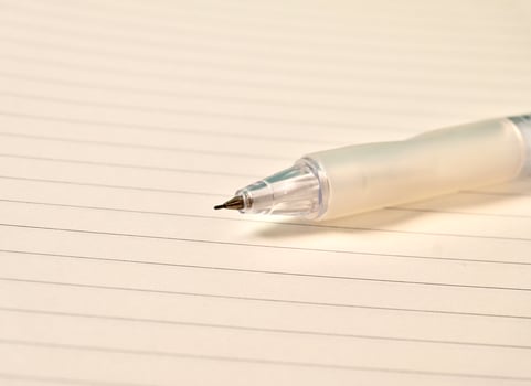 Close up note book with white lined paper and sharp mechanical pencil lead isolated on horizontal background. photo