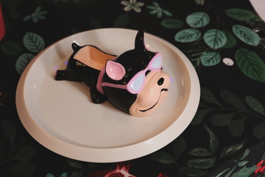Adorable Cute Cartoon Pig Figurine Wearing Sunglasses on a Decorative Plate for Display photo