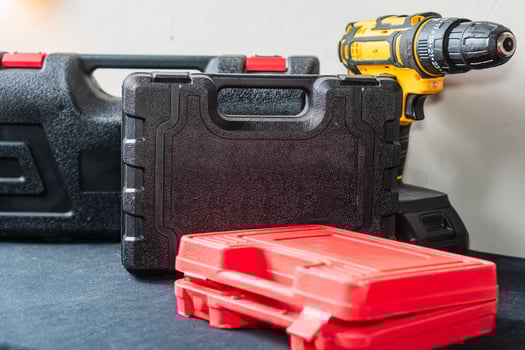 Tool Cases and Power Drill on Black Surface photo