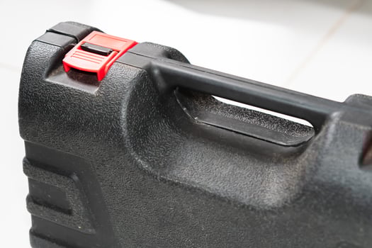 Close-Up of a Black Tool Case with Red Latch photo