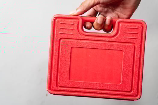 Red Plastic Toolbox Held by Hand photo