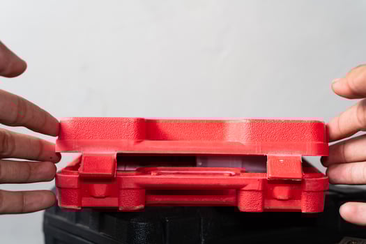 Hands Opening a Red Tool Case photo