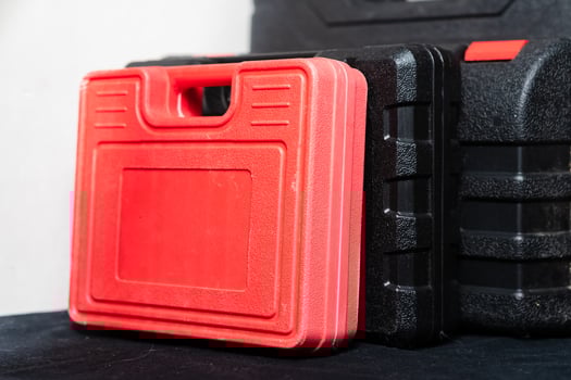 Red and Black Toolboxes on Dark Surface photo