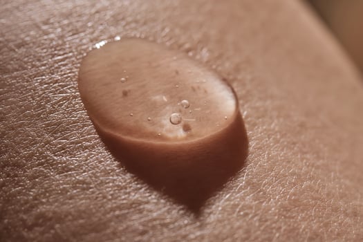 Body fluid or cosmetic gel on human skin. photo