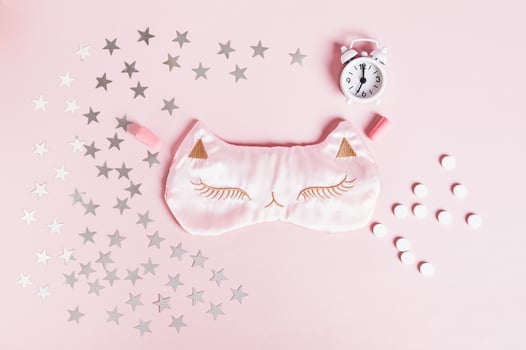 Concept good sleep, sleeping pills, sleep mask and stars on pink background photo