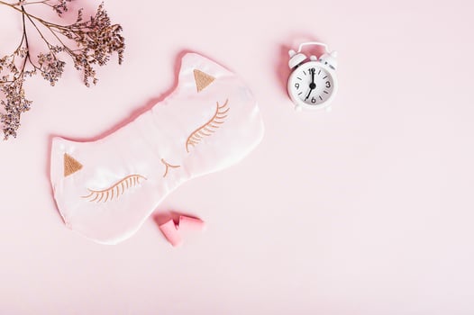 Concept insomnia sleep mask, earplugs and alarm clock on pink background photo