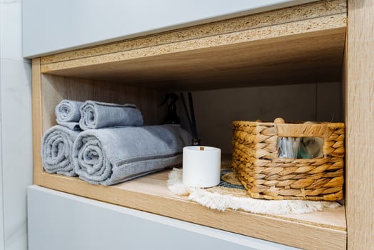 Discover a stylish bathroom storage solution featuring beautifully rolled towels alongside a decorative basket to enhance your space photo