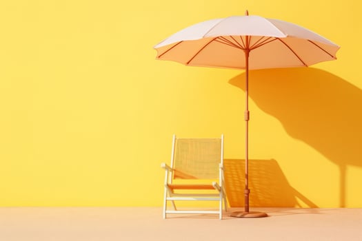 A chair and umbrella sit against a yellow wall photo