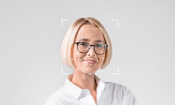 A woman smiles while being analyzed by facial recognition technology. This image highlights advancements in ID technology and how it is used for identification purposes in various fields. photo