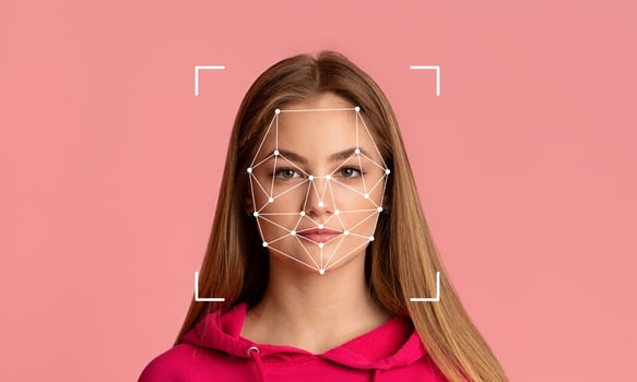 A young woman is featured with facial recognition technology overlaying her face. photo