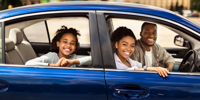 Happy Black Family In New Blue Car Posing Smiling To Camera Having Ride In City. Parents And Preteen Daughter Sitting In Luxury Auto. Automobile Ownership And Purchase Concept. Selective Focus photo