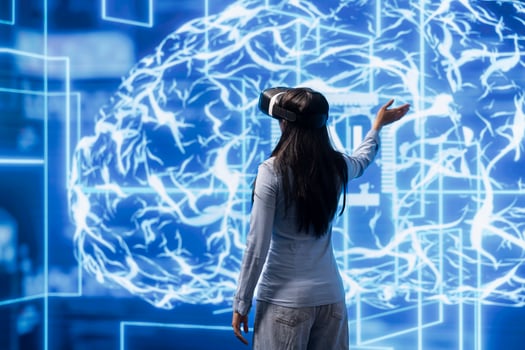 Engineer wearing VR headset, working with artificial intelligence neural networks to process datasets for training. Technician using virtual reality technology supporting AI applications and workloads photo