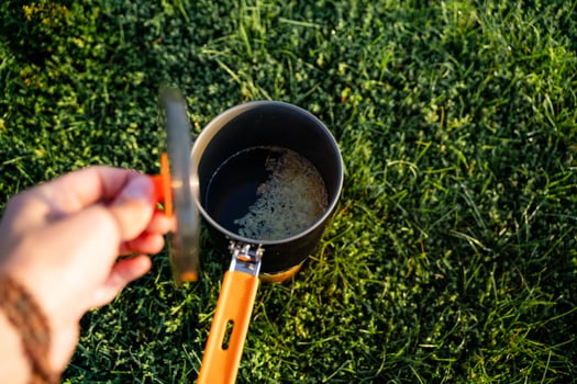 Outdoor Cooking Preparing Delicious Hot Beverages on Lush Green Grass for an Enjoyable and Memorable Experience photo