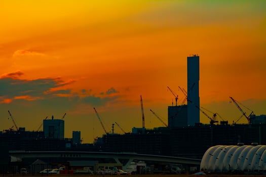 Cranes at the under construction in Tokyo at dusk photo