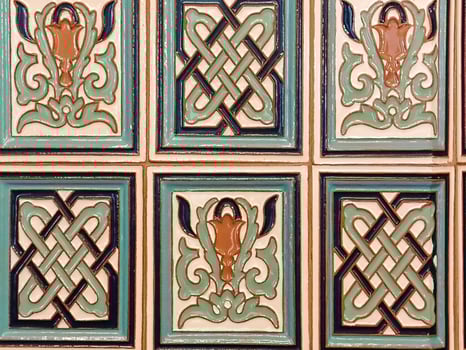 A close up of a wall with decorative tiles photo