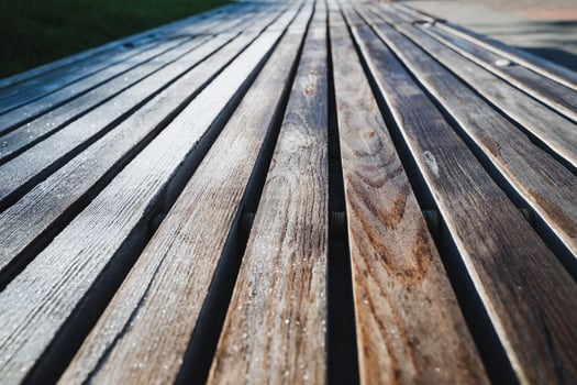 This image features a closeup view of a beautifully crafted wooden deck that showcases a striking diagonal pattern, emphasizing the unique textures and hues of the wood surface photo