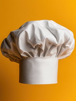 White chef hat on yellow background photo
