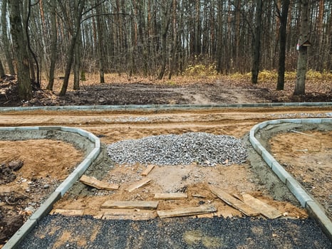 A new road is being built in a lush forest, causing significant disruptions to the local environment and severely impacting the surrounding ecosystem and wildlife populations photo