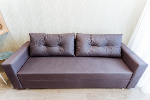 Brown rectangle couch in living room by window for comfort photo