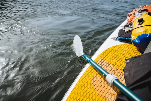 paddle paddling on the water, paddleboarding on the river, summer rafting on the lake, hiking gear. photo