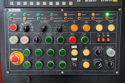 A control panel prominently features a bright red button labeled Emergency Stop, ensuring immediate action can be taken in case of a machinery malfunction or urgent safety situation photo