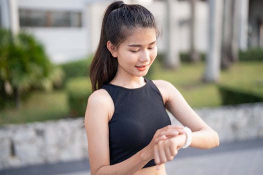 asian woman checking her smart watch. photo