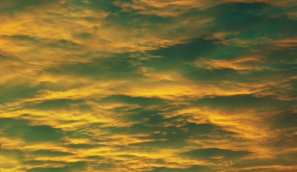 Impressive yellow and green cloudscape in the evening photo