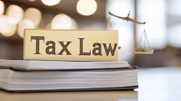 Tax law sign on book with scales of justice, symbolizing legal concepts photo