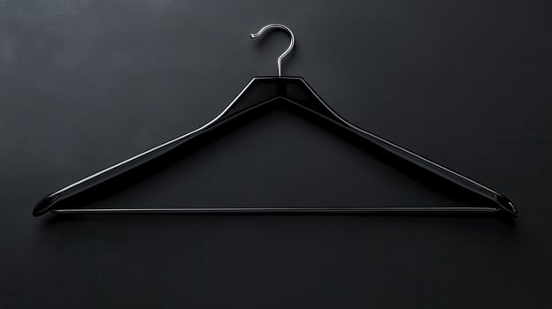 Hanger on a black background creating a minimalist design suitable for fashion displays or textile presentations photo