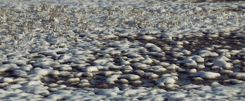 Snow formations on frozen water photo