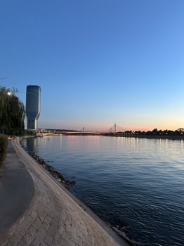Riverside view at sunset in Belgrade, showcasing modern architecture and calm Danube river. Urban architecture in Serbia photo