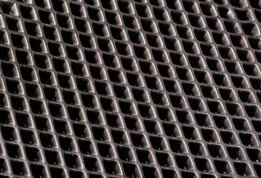 Beautiful background made of rubber mat with indentations, close-up photo