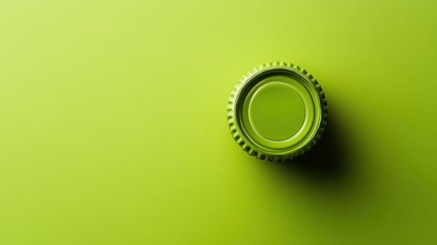 Bottle cap resting on a vibrant green surface capturing the essence of minimalism and simplicity in design photo