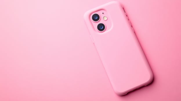 Pink smartphone rests on a pastel surface, showcasing modern design and aesthetic appeal in a minimalistic setting photo
