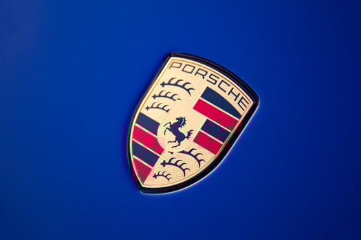 Vilnius, Lithuania, 2024 - Porsche gold emblem logo on a hood of Porsche Taycan photo