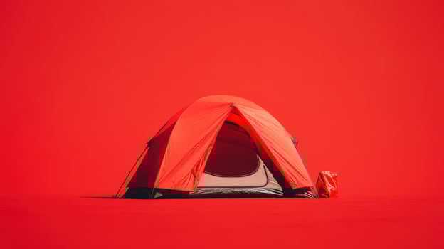 Bright red camping tent set against a vibrant red backdrop in an outdoor environment photo