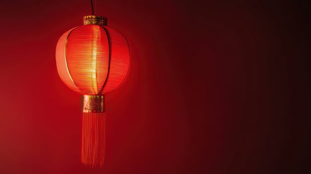 Bright red lantern hanging against a dark wall, adding a touch of warmth and tradition to the space photo