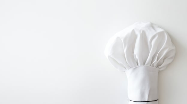 A white chef hat on a white surface photo