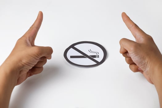 Human hands holding round paper no smoking sign photo