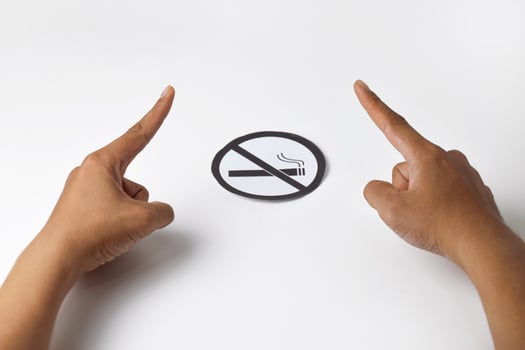 Hands showing warning gesture with no smoking sign photo