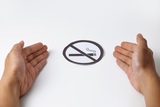 Hands holding a no smoking sign on white background photo
