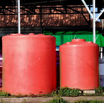 red plastic water tank in outdoor. photo
