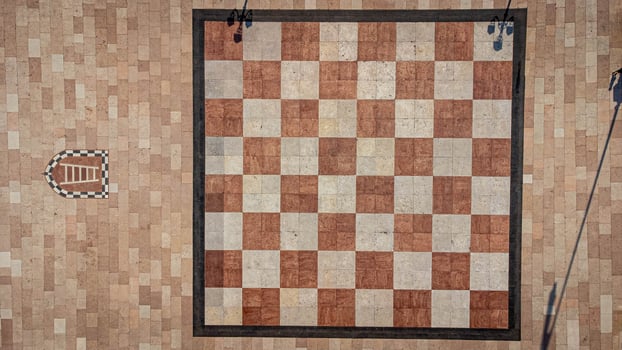 Large chessboard seen from above. Chess square in the center of Marostica, a medieval town in Italy. Texture and background of chessboard squares photo