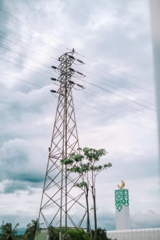 A tall transmission tower against a vibrant blue sky so nice photo