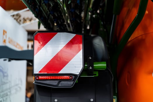 A close up of a tractor with a red and white stripe photo