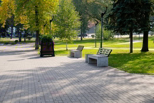 A winding path in a serene park with inviting benches and vibrant greenery offers a perfect escape for relaxation and leisurely strolls photo
