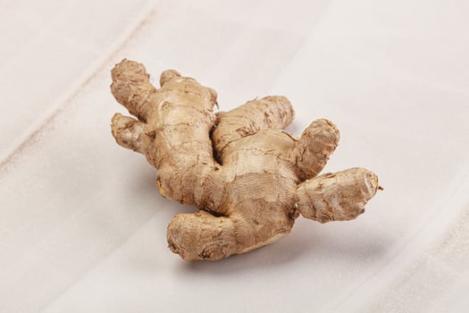 A ginger root on a white surface photo
