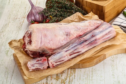 A large piece of meat on a cutting board photo