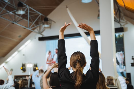 A leisure event with people raising arms in fun gesture photo