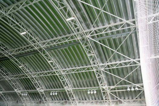 The ceiling of a large building with a green roof photo